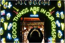 Guinness-inspired neon lights on the outside a local pub, bearing the wording 'Good things are in our grasp'