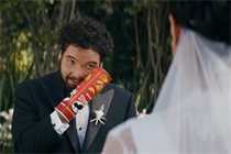 Pringles Super Bowl ad showing man with hand stuck in can of Pringles