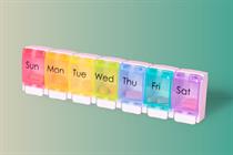 Weekly dispensers of prescription pills labeled by days of the week. 