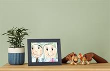 Child's crayon drawing of parents framed in a digital picture frame