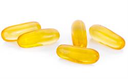 Transparent yellow soft capsules on a white background.