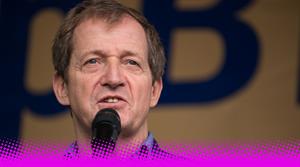 A photograph of Alastair Campbell giving a speech into a microphone