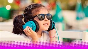 Kid listening with headphones - stock image