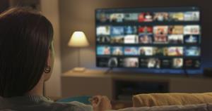 Photograph of woman watching TV