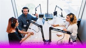 A photograph of three people recording a podcast around a table