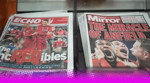 A photograph of a stack of Liverpool Echo and Daily Mirror newspapers