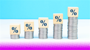 Percentage sign on coin stacks - stock photo