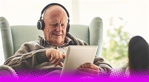 stock photo - old man listening with headphones and tablet