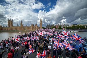 Crowds of people with flags march across Westminster Bridge during September's Unite the Kingdom rally. (Photo: Christopher Furlong/Getty Images)