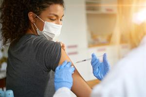 A woman getting vaccinated 