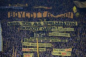 Dortmund fans display banners demanding a boycott of the 2022 FIFA World Cup in Qatar during the German first division Bundesliga football match (Ina Fassbender/Getty Images)