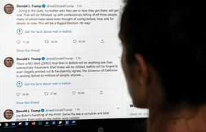 A Twitter user views tweets by former President Donald Trump in 2020. (Phot credit: Getty Images). 