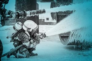 Firefighters spraying foam. Image: Getty