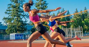 Image of female sprinters crossing the finishing line