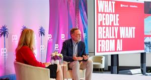 Nathalie Krup and Grant Owens on stage at Possible, a screen next to them reads What people really want from AI