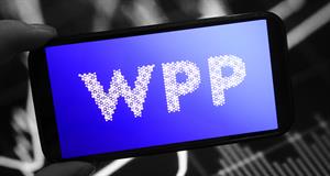 Hand holding smartphone displaying WPP logo