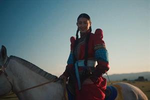 A Mongolian woman on a horse