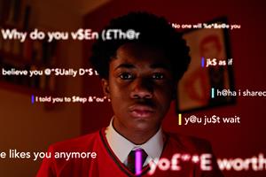 A schoolboy with abusive messages overlaid on the screen