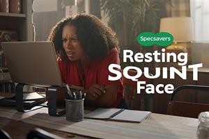 A woman squinting at her computer with text overlaid saying: Specsavers - Resting squint face