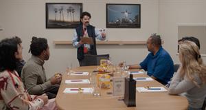 A focus group convening six participants sitting around a table