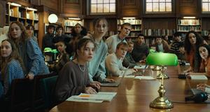 Interior of a college campus library populated with students, each of whom has a doppelgänger