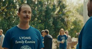 A man at a family reunion wears a shirt reading 