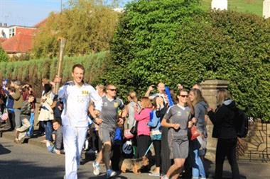 Scotland's physical activity champion, GP Dr Andrew Murray, carries the Olympic torch