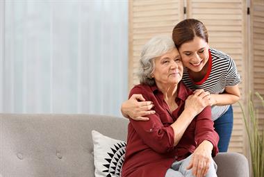 An older woman being hugged by a younger woman
