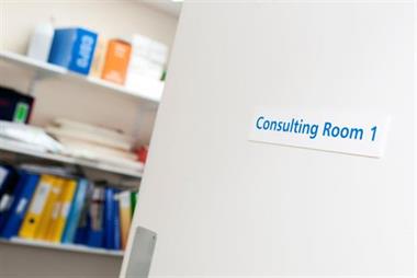 Open door to GP surgery consulting room