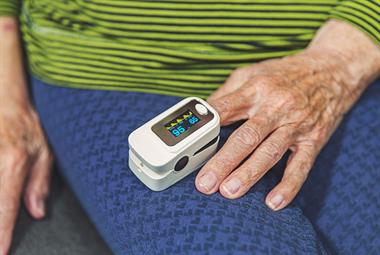 Elderly patient using a digital pulse oximeter