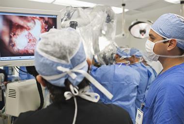 Surgeon looking at a monitor in an operating theatre