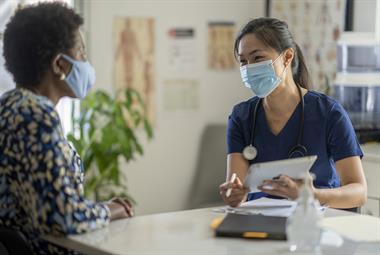 A health professional in a consultation with a patient
