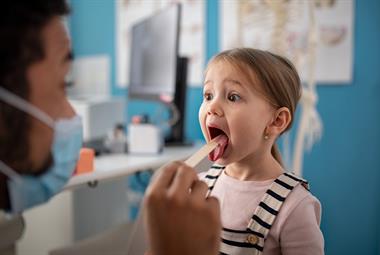 Doctor examining a child's throat