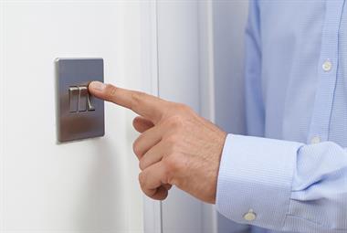Close up of a man turning off a light switch