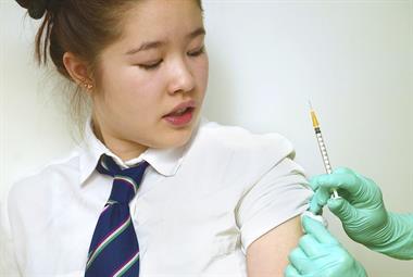 School girl receiving vaccination