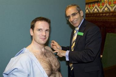 Semi-naked health minister receives flu jab.