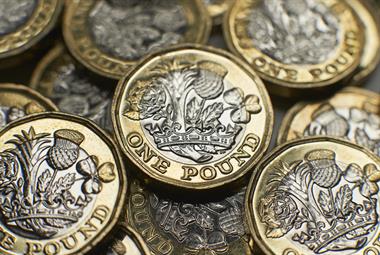 Close-up photo of a pile of £1 coins