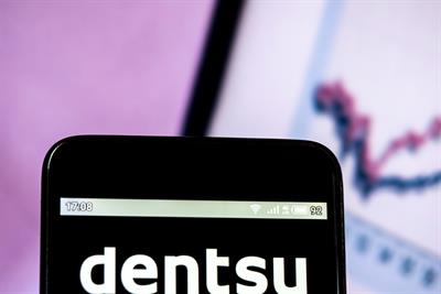 Dentsu logo on a smartphone