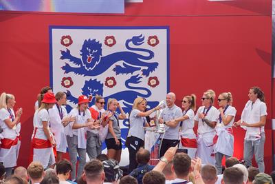 The England team celebrates on the stage during the Women's Euro 2022 special event in Trafalgar Square