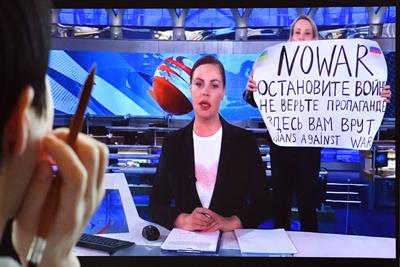 Image of anit-war protester on Russian news channel