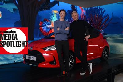 Max Fosh and Olly Murs stand in front of a red Toyota Yaris