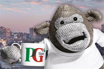 A monkey puppet holding up a cup PG Tips tea