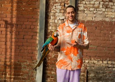Pete Davidson with a parrot