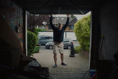 Still from campaign showing a man opening the garage door