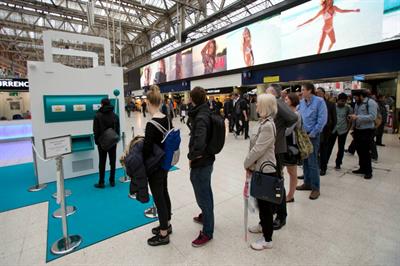 Commuters queue up for Deliveroo's slot machine game at London Waterloo