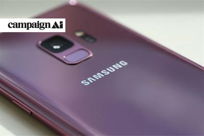 Purple Samsung smartphone on its front with the back camera pointing upwards