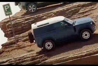 A Land Rover reversing into a parking space situated on the edge of a precipice