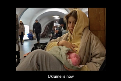 A woman shelters in the metro system, clasping a baby