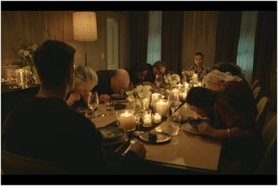 Table of dinner guests spitting their food out onto their plates in disgust