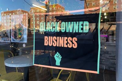 Store with Black owned business sign in window